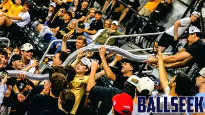 Fans build a cup snake during the game